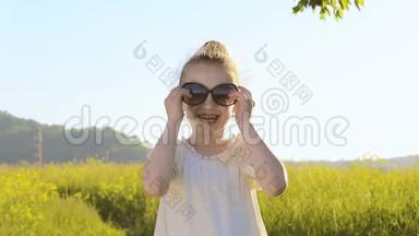一个可爱的小女孩戴上一副太阳镜，微笑着
